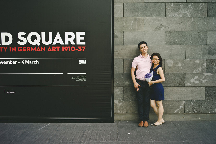 Melbourne couple engaged next to NGV poster