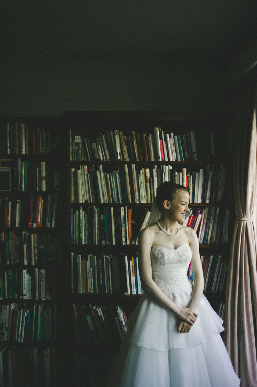 Bride in front of bookshelf in Melbourne