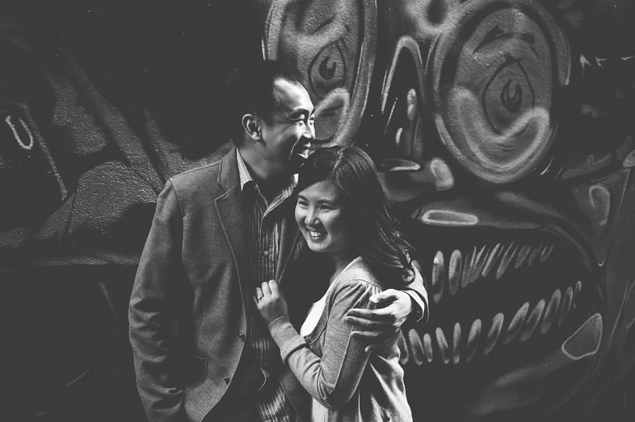 Couple embracing in front of Melbourne graffiti wall