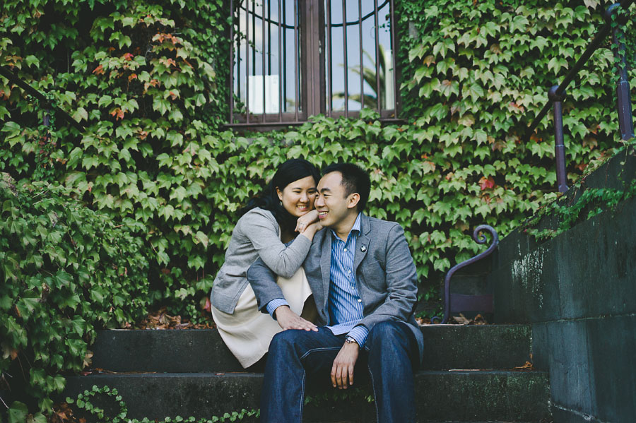 Engagement couple sitting in front of Barracks building