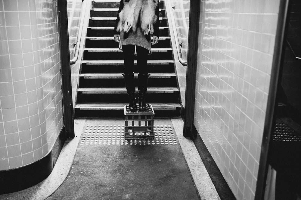 Girl standing on milk crate Flinders station Melbourne