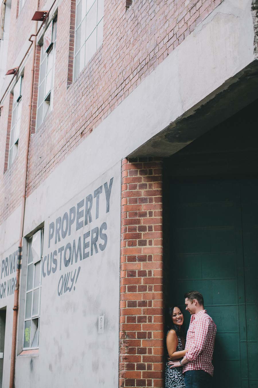 Couple embracing in front of Melbourne parking lot