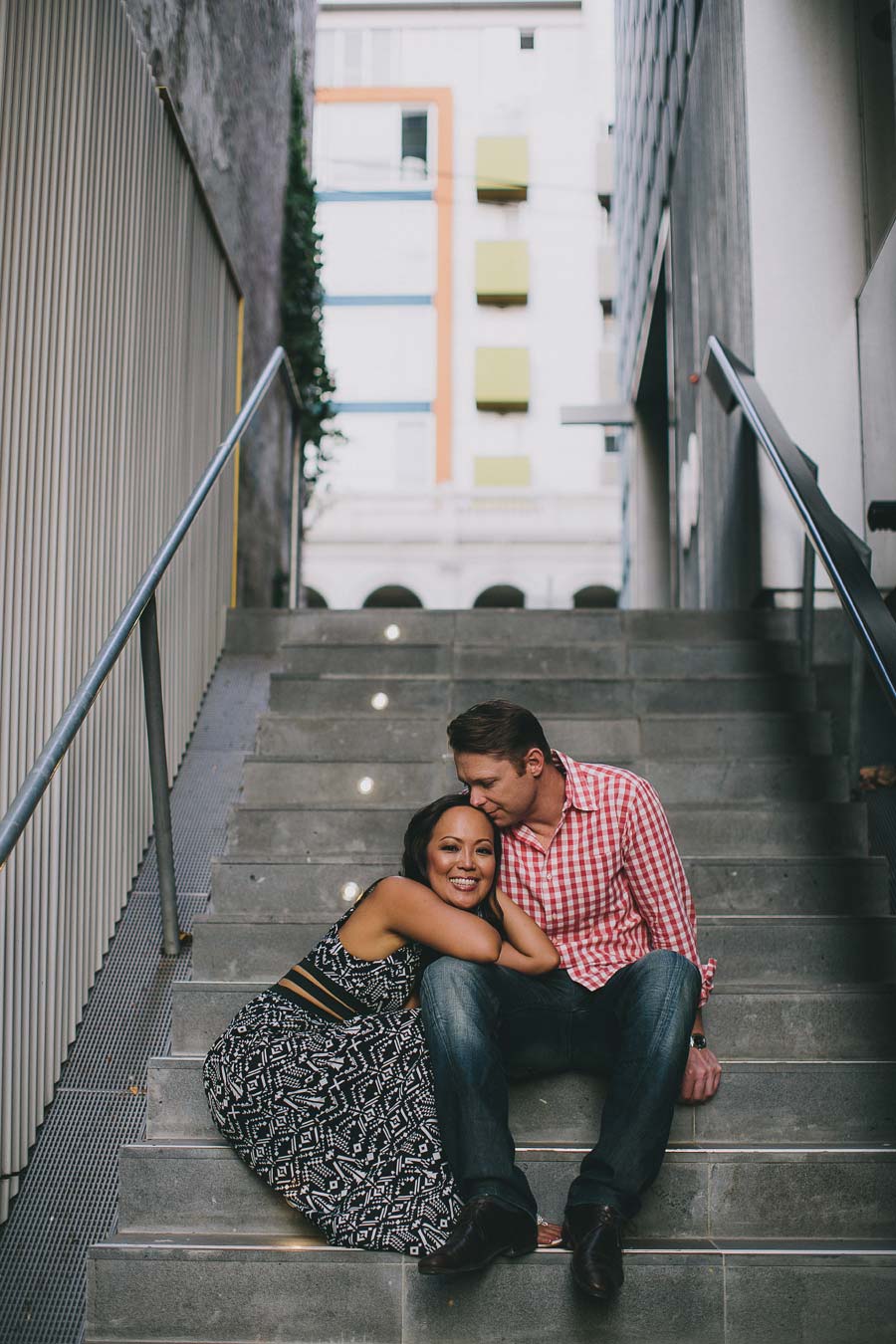 Melbourne engaged couple sitting on stairs