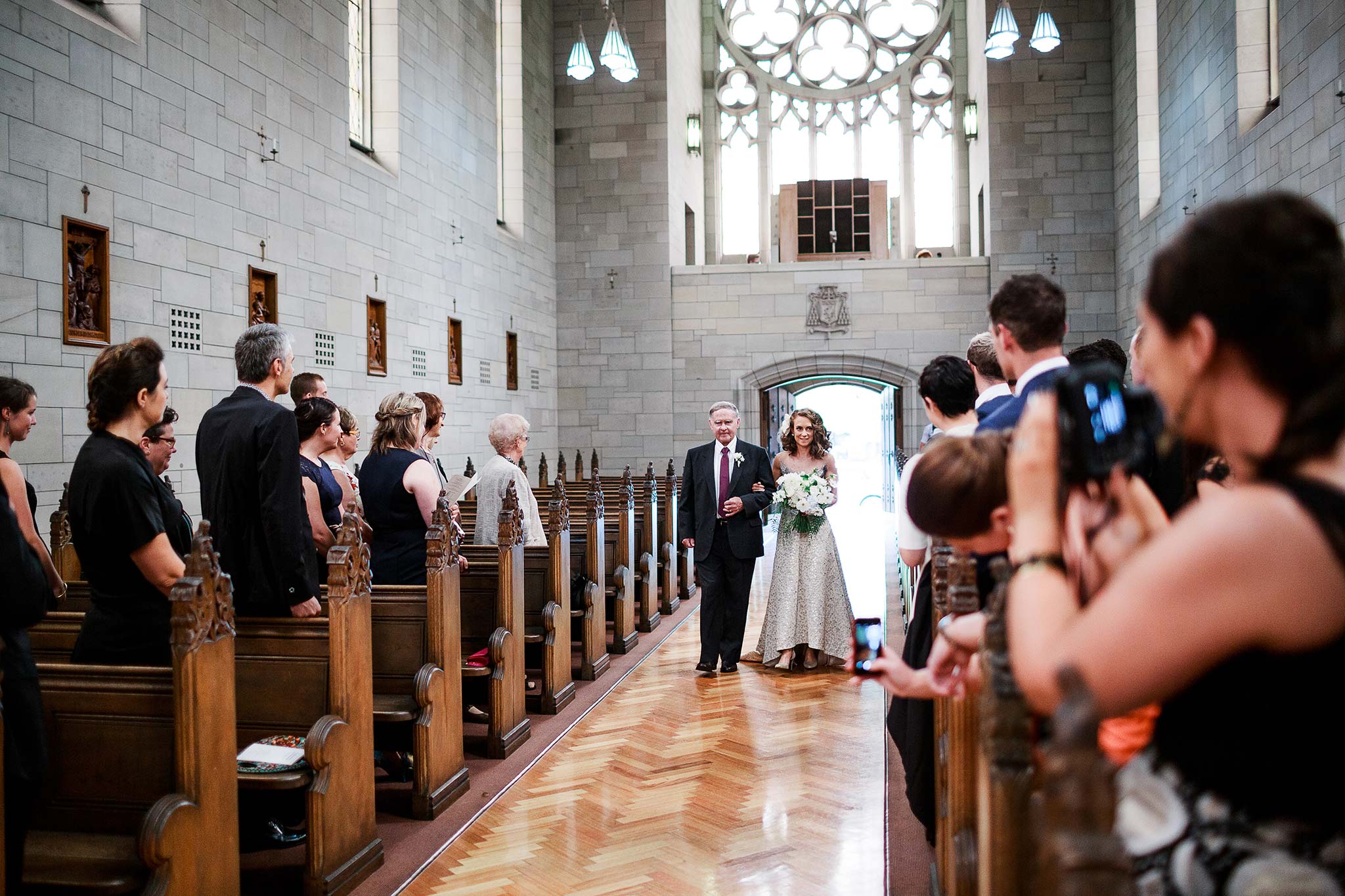 Newman-college-wedding-photographer-ceremony-bride-entrance