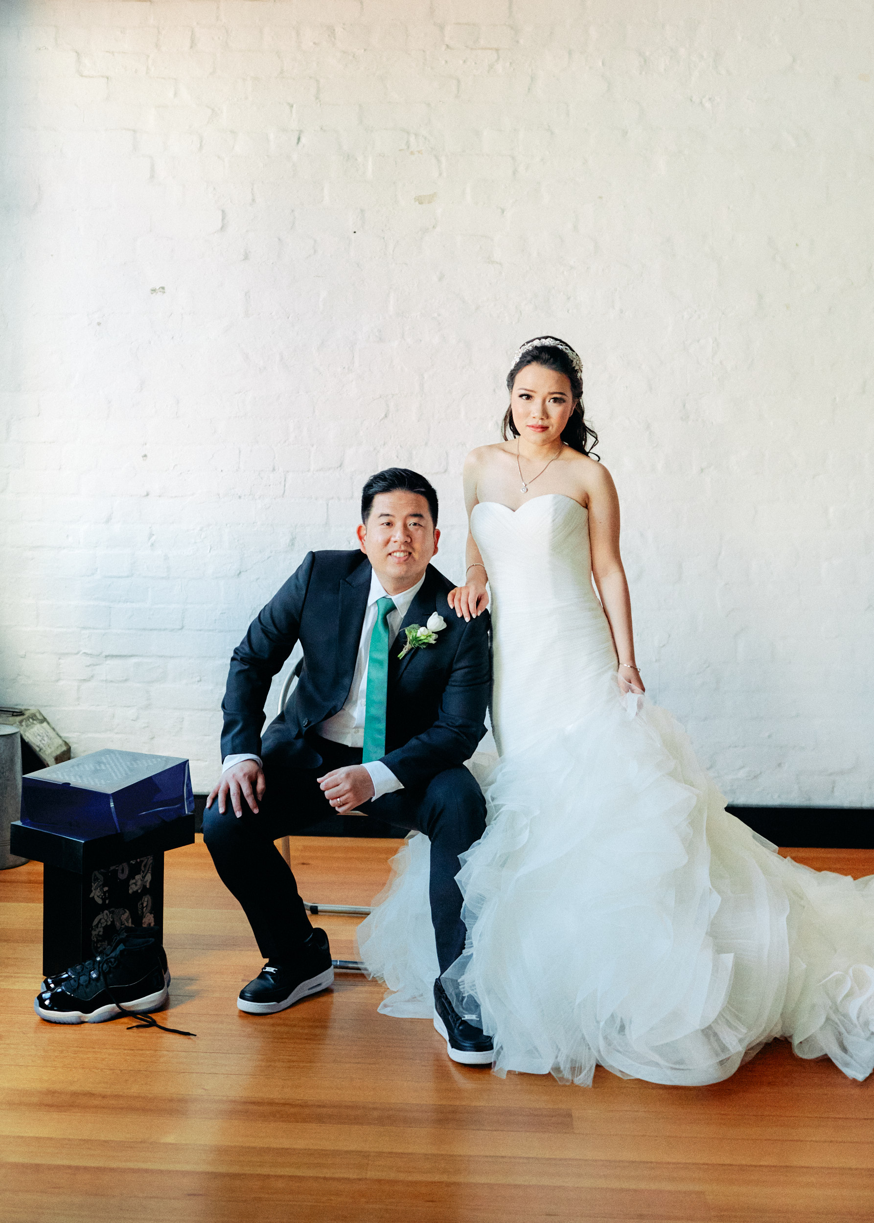 bride and groom with air jordan shoes before reception above Krimper cafe