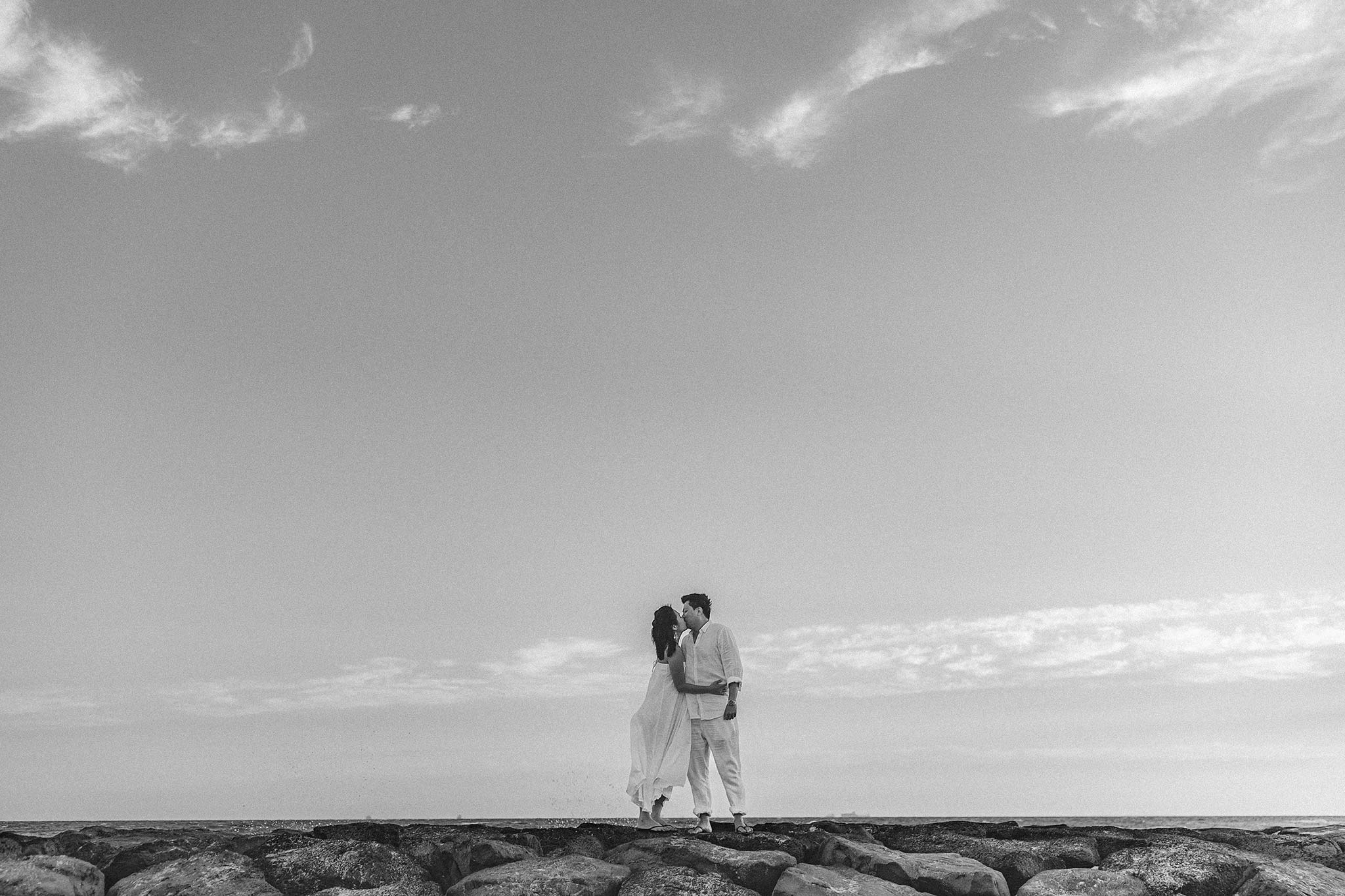 Melbourne Williamstown Pre Wedding Engagement black and white couple kissing with sky background