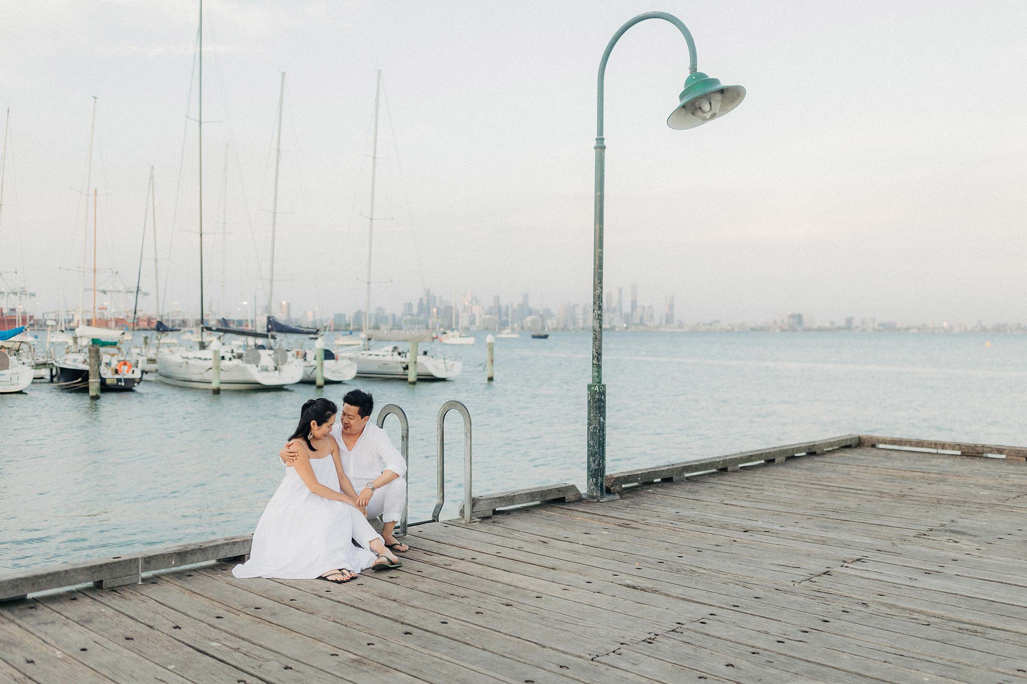 Melbourne Williamstown Pre Wedding Engagement sitting down on jetty